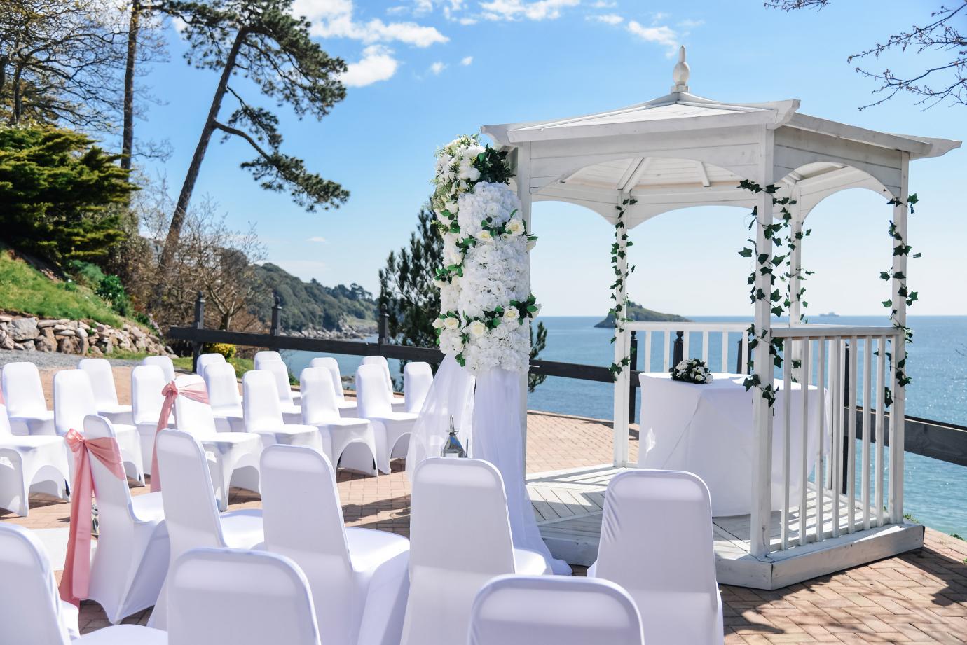 Wedding ceremony outside of the osborne hotel with the sea view