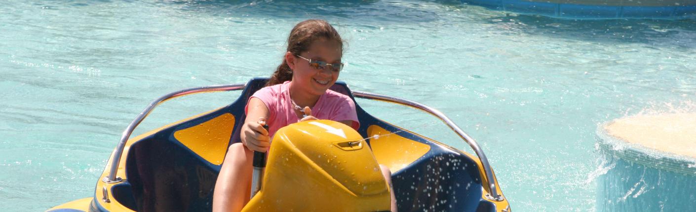 Girl on a bumper boat at an adventure park