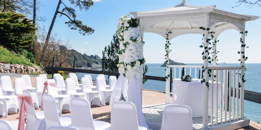 Wedding ceremony outside of the osborne hotel with the sea view